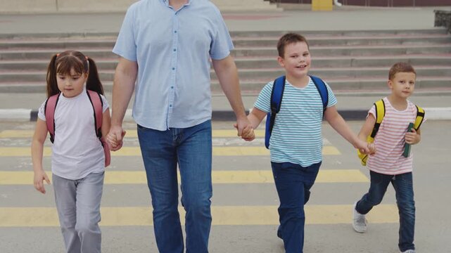 Family walking to education, School safety awareness, Parental love, Step by step to school, Siblings united by hand, Confident walk to class, Morning city life, Fatherly protection, Ready for school