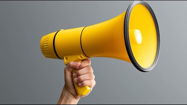 Yellow megaphone held firmly in hand