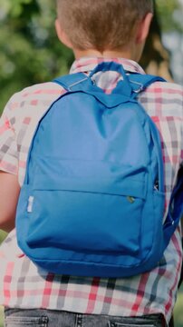 happy Child kid schoolboy backpack rides scooter school, elementary school classwork, education outdoor activity, junior scholar backpack, boy backpack lifestyle, kid recess scooter, child academic