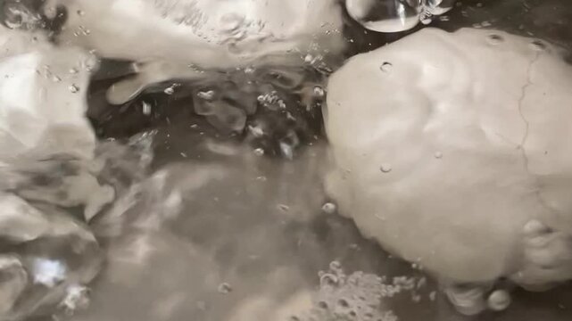 Boiling Fresh Eggs in Pot of Water on Stove