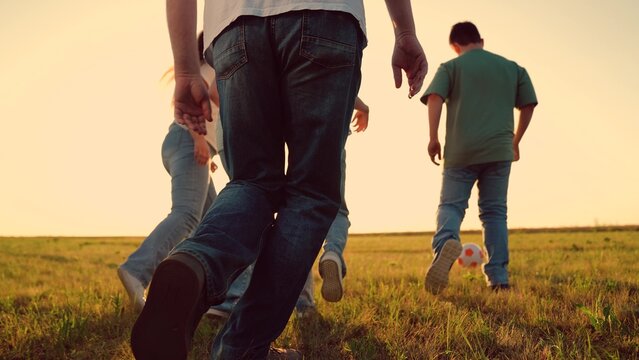 Parents run with child kid playing football green lawn, children kicking ball, mother father girl boy happy family sunset, simple happiness., love, connection., lifestyle, parenting tips, health