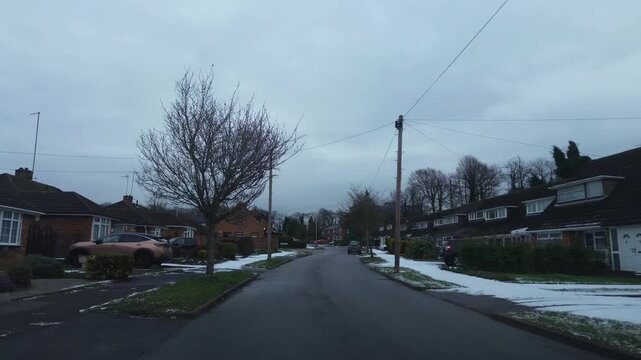 Car Drive on Luton Streets and Roads of England Great Britain After Light Snowfall. Car Mounted Wide Angle Camera Footage Was Captured During Mostly Cloudy and Rainy and After Snow Falling Day