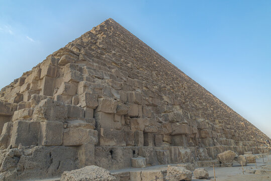 The famous Cheops pyramid (also known as Khufu pyramid, or Great Pyramid), Cairo, Egypt. View from one corner. Blue sky on the background.