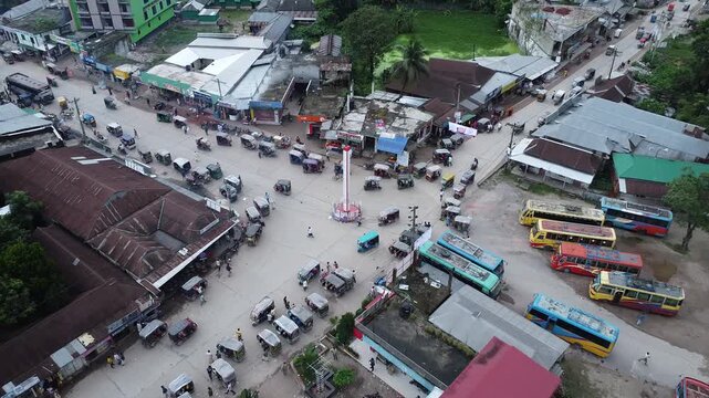 High angle drone shot of a rural road junction with public buses and local transportation in south asia aerial traffic rickshaws transport urban aerial traffic rickshaws transport urban