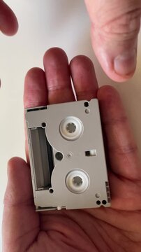 Hands Holding MiniDV Videotape Cassette Close Up