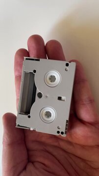 Hands Holding MiniDV Videotape Cassette Close Up