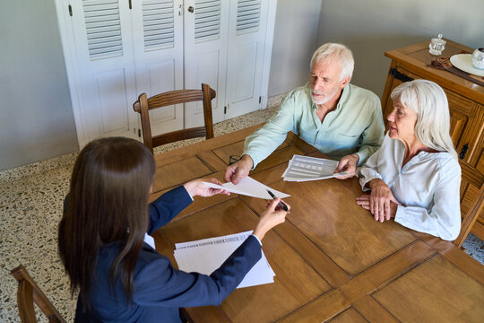 Retirement Planning And Financial Protection: Senior Couple Discussing Estate With Advisor For Long-Term Security