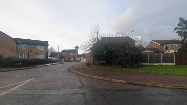 Car Drive on Luton Streets and Roads of England Great Britain After Light Snowfall. Car Mounted Wide Angle Camera Footage Was Captured During Mostly Cloudy and Rainy and After Snow Falling Day