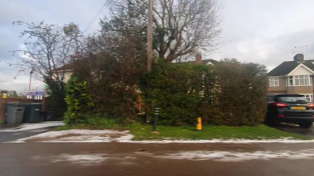 Car Drive on Luton Streets and Roads of England Great Britain After Light Snowfall. Car Mounted Wide Angle Camera Footage Was Captured During Mostly Cloudy and Rainy and After Snow Falling Day