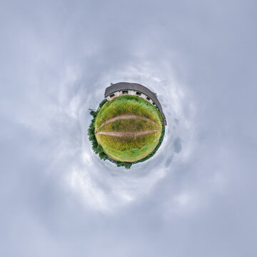 simple little tiny planet without buildings in blue sky with sun and beautiful clouds. Transformation of spherical panorama 360 degrees. Spherical abstract aerial view. Curvature of space.