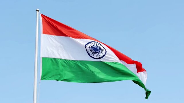 Indian national flag waving proudly against a clear blue sky tricolor symbol of patriotism
