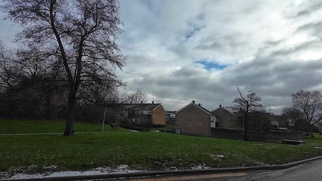 Car Drive on Luton Streets and Roads of England Great Britain After Light Snowfall. Car Mounted Wide Angle Camera Footage Was Captured During Mostly Cloudy and Rainy and After Snow Falling Day
