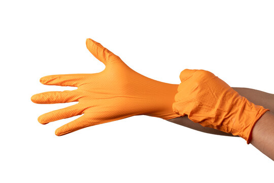 Hand putting on orange nitrile safety glove