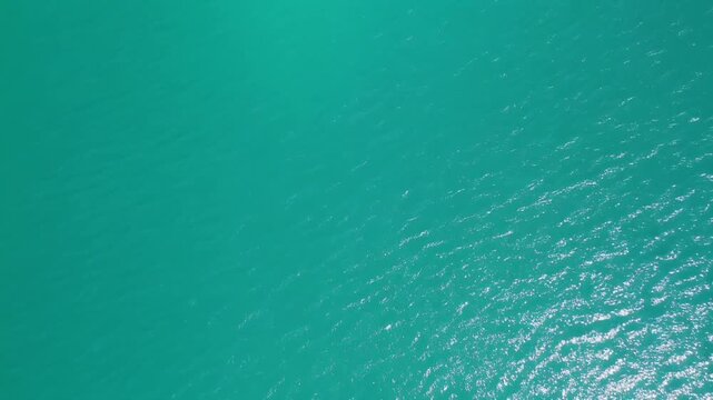 Top Down Aerial View of Rippling Turquoise Water Surface in Bright Summer Sunlight, Clear Lake Background 1080p