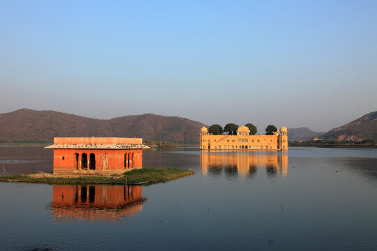 Jal Mahal reflected in the tranquil waters of Man Sagar Lake during golden hour in Jaipur, Rajasthan, India