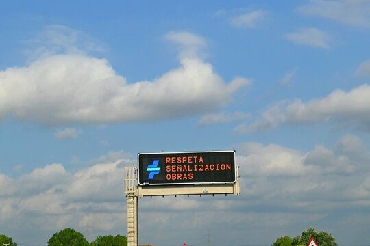 An electronic information board with variable content, located above the A-6 motorway in Spain. The board displays the message Obey traffic signs during roadworks, June 29, 2026