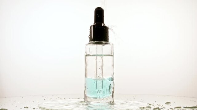 Glass bottle with pipette for collagen serum, oil, liquid, emulsion on the mirror table. Cosmetic products for face and body skin. Packaging for design, advertising of a cosmetic product. 4k 