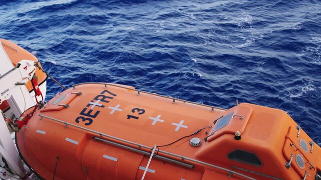Lifeboat Ready for Emergency on Cruise Ship Deck, Ocean Waves
