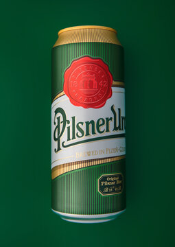 LONDON,UK - MARCH 20, 2026: Can of Pilsner Urquell Czech lager beer on green background. Top view.