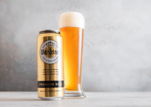 LONDON,UK - MARCH 12, 2026: Glass of cold Warsteiner brewers gold lager beer and aluminium can on light table background.