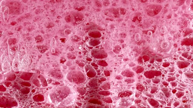 Transparent Gel Fluid, Serum, Oil with bubble flows down a Cosmetic Sponge. Moisturizing Hyaluronic acid, Cream Texture. Skin or Body Care Products. Macro Shot of Natural Organic Cosmetics. 4k