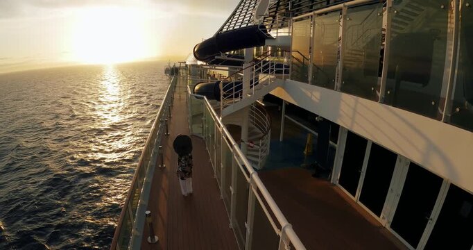 Woman Strolls Cruise Deck at Sunset - Aerial View