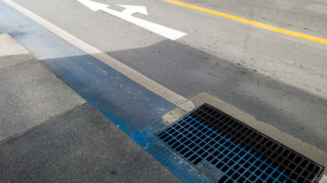 White direction arrow on asphalt road with copy space, business direction and traffic navigation concept