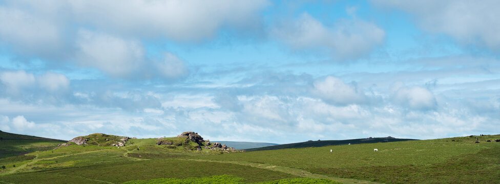 hills and rocks in national poark dartmoor on sunny day in spring