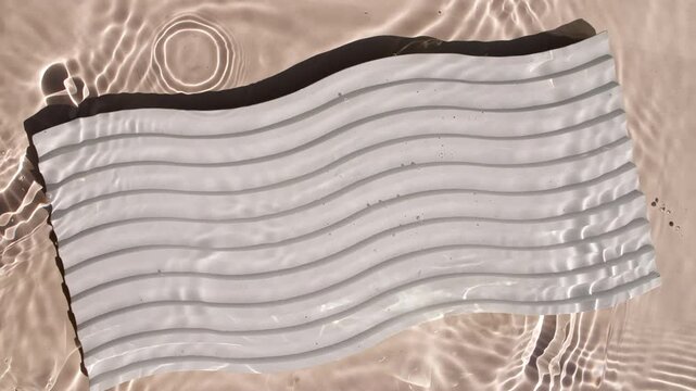 Pure water with reflections sunlight in slow motion. Water surface texture top view. Sun and shadows. Motion clean swimming pool ripples and wave. High quality 4k footage