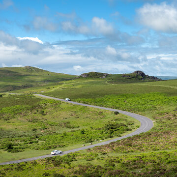 white cars on road in dartmoor national park