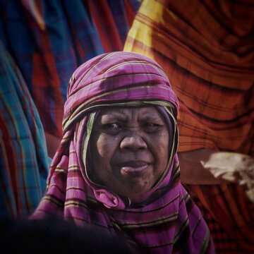Portrait of elderly Asian woman in traditional fabric head covering