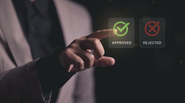 Business executive using digital interface to select approved status