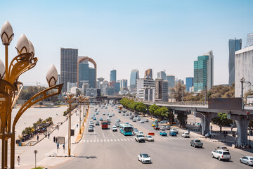 Bustling urban landscape of Addis Ababa, Ethiopia, featuring modern skyscrapers, vibrant multi-lane traffic, and ornate street lamps under a bright sky. © Agnieszka Gaul