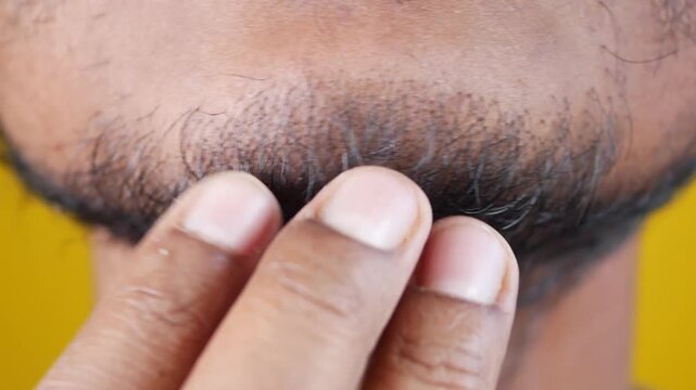 Close up of man touching his beard stubble slow motion
