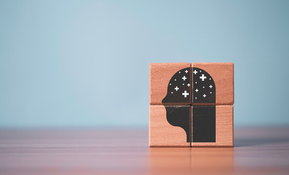 Positive thinking concept with a human head icon made from wooden blocks, representing optimism, growth mindset, mental wellness, confidence, emotional resilience and personal development.