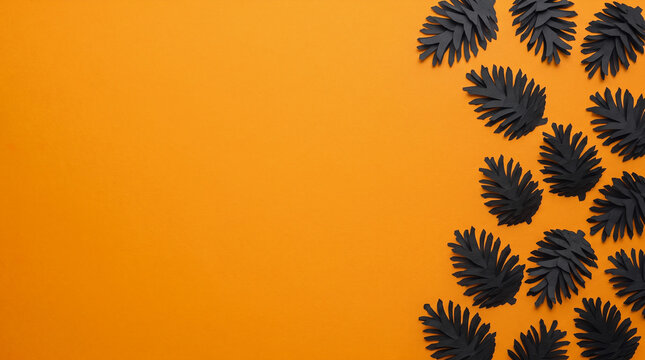 Autumn orange background featuring pine cones paper cut out right border with clean copy space for seasonal banner, greeting card, poster, invitation, harvest festival and fall design