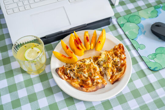 A working lunch at the desk&mdash;pizza and fruit juice.
