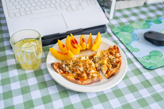 A working lunch at the desk&mdash;pizza and fruit juice.