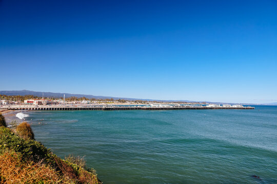 Santa Cruz Boardwalk Pier and Coastline with Blue Ocean and Clear Sky on a Sunny Day