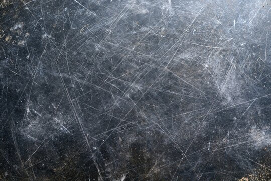 The Weathered Scratched Metal Surface with Industrial Texture and Rugged Patina
