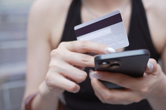 credit card.  Woman making an online purchase using a mobile phone. and digital shopping e-banking. concept  e-commerce make purchase or booking reservation. internet investment on mobile app.