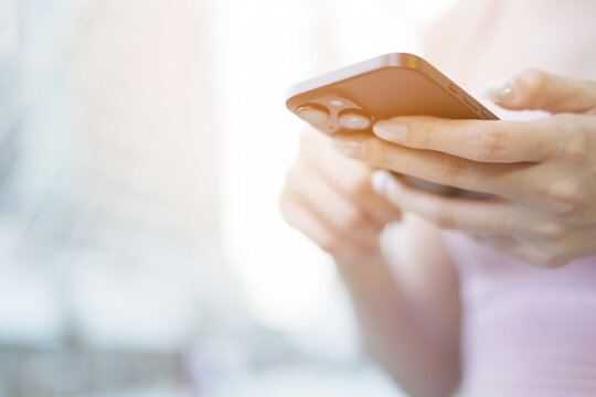 woman holds smart phone in her hands and scrolls through the news feed. Close up of hand uses mobile. point finger on screen, texting text message.	