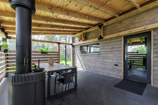 Covered Outdoor Terrace with Dining Area and Wood Stove