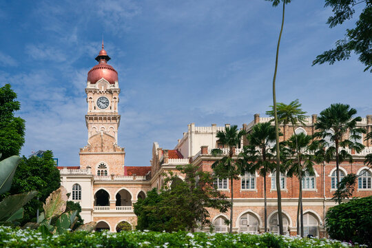 Sultan Abdul Samad Building clock tower under a clear blue sky in Kuala Lumpur city center, Malaysia.