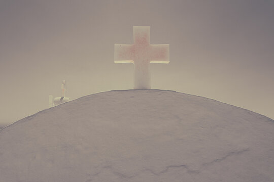 Minimalist white cross atop a smooth rooftop in Greece, softly illuminated by sunrise light, symbolizing peace, faith, and serenity.