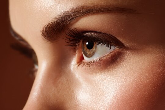 Close-up portrait of a woman's expressive brown eye and skin