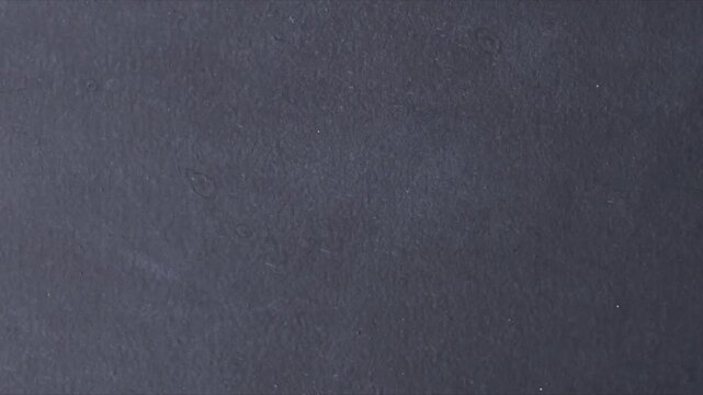 Scratched damaged dynamic overlay texture surface in trendy vintage stop motion style. Grunge abstract dark crumpled scratch paper texture backdrop overlay.  cloth surface texture background video.