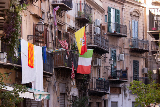 Palermo, Italy; January 1st 2026: City balconies displaying the flags of the city and Sicily.