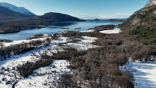 National Park In Ushuaia Fin Del Mundo Argentina. Birds Eye View Of Stunning Dark River And Forest Trees. Nature Travel Destinations Snow Covered Forest Trees. Exploration Snow Covered Aerial.