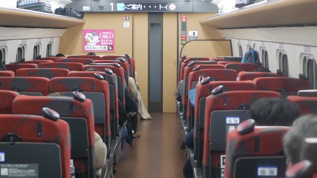 landscape view inside highspeed train commuter while moving fast with sunlight shining through train window, interior inside highspeed train full with passenger in Japan railway transportation